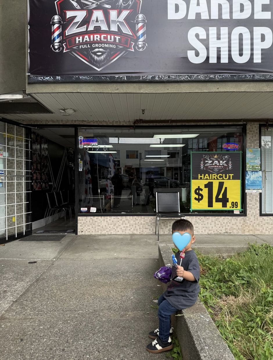 Shopfront on Victoria Drive with Zak Haircut signage